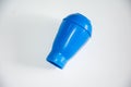The blue plastic object is placed in the center of a pure white background, with a unique shape and textured surface Royalty Free Stock Photo