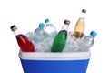 Blue plastic cool box with ice cubes and refreshing drinks on white background Royalty Free Stock Photo