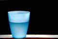 Blue plastic cup with water inside.