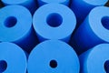 Blue plastic cylinders with holes in the center