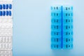 Blue plastic 14 day pill box with pills on blue background. Top view Royalty Free Stock Photo