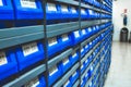 Blue plastic draws of stock / parts in rows of shelves