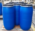 Blue plastic drums on wooden pallet Royalty Free Stock Photo