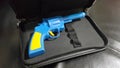 Blue plastic gun A yellow handle and trigger is placed Royalty Free Stock Photo