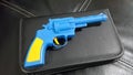 Blue plastic gun A yellow handle and trigger is placed Royalty Free Stock Photo