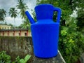 Blue Plastic Kettle / Jug with Outdoor Background Royalty Free Stock Photo