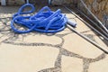 Blue plastic long large corrugated hose for cleaning the pool wash and watering the plants