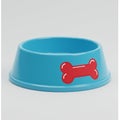 Blue plastic pet bowl with a wide rim and deep basin, featuring a red bone graphic on the Royalty Free Stock Photo