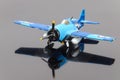 Blue plastic plane on the grey mirror background Royalty Free Stock Photo