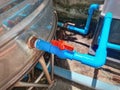 Blue Plastic PVC Ball Valve Connected to Rusty Water Tank