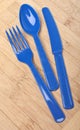 Blue Plastic Silverware on a Wooden Background Royalty Free Stock Photo