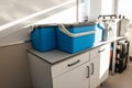 Blue plastic storage boxes on a laboratory counter.Automatic sampler equipment in laboratory setting Royalty Free Stock Photo