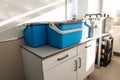 Blue plastic storage boxes on a laboratory counter.Automatic sampler equipment in laboratory setting Royalty Free Stock Photo