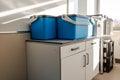 Blue plastic storage boxes on a laboratory counter.Automatic sampler equipment in laboratory setting Royalty Free Stock Photo