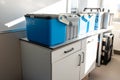 Blue plastic storage boxes on a laboratory counter.Automatic wastewater sampler equipment in laboratory setting Royalty Free Stock Photo