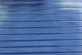 Blue plastic striped polycarbonate surface in the sun