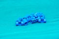 Blue plastic surgical clips for scalp hemostasis in brain surgery on green table in operating room