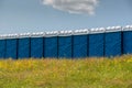 Blue plastic toilets in row at local horse race Royalty Free Stock Photo