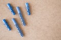 Blue plastic wall plugs on the brown background Royalty Free Stock Photo