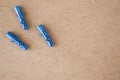 Blue plastic wall plugs on the brown background Royalty Free Stock Photo