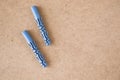 Blue plastic wall plugs on the brown background Royalty Free Stock Photo