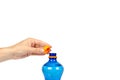 Blue plastic water bottle with orange cap, isolated on white background, with hand, copy space template Royalty Free Stock Photo