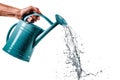 A blue plastic watering can in hand isolated on a white or transparent background. Close-up of the watering can in hand Royalty Free Stock Photo