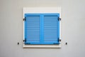Blue plastic window shutters on a wall of residential building Royalty Free Stock Photo