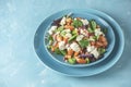 Blue plate of fresh superfoods healthy salad with red onion, tomatoes, doucette lambs lettuce, corn salad, field salad and feta Royalty Free Stock Photo