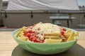 Blue plate of macaroni and cheese and tomato served Royalty Free Stock Photo