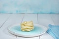Blue plate with a nest of dry unpaired tagliatelle, cooking ingredients Royalty Free Stock Photo