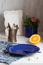Blue plate, orange and vintage kettle Royalty Free Stock Photo