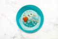 A blue plate with a piece of bread and breadcrumbs on a marble kitchen counter Royalty Free Stock Photo