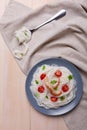 In a plate, rice noodles with tomatoes, king prawn and greens. View from above. Indoors. Royalty Free Stock Photo