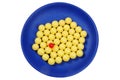 Blue plateful of yellow drops vitamin and red pill Royalty Free Stock Photo