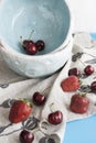 Blue plates with red juicy strawberries and delicious cherries Royalty Free Stock Photo