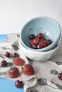 Blue plates with red juicy strawberries and delicious cherries Royalty Free Stock Photo