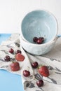 Blue plates with red juicy strawberries and delicious cherries o Royalty Free Stock Photo