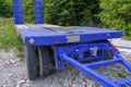 Blue platform trailer truck close-up. Transportation equipment. Logistics element. Heavy machinery