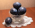 Blue plums in a glass vase. Royalty Free Stock Photo