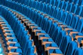 Blue plush chairs with wooden armrests in the auditorium. Empty auditorium in the theater