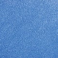 Blue plush terry cloth bath towel macro background
