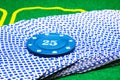 Blue poker chip on a deck of playing cards Royalty Free Stock Photo