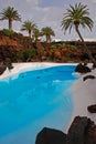 Blue pool & palm trees of Jameo Grande, part of Jameos Del Agua, by CÃÂ©sar Cesar Manrique in Lanzarote, Spain Royalty Free Stock Photo