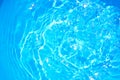 Blue pool water with sun reflections.Shining blue water ripple background.water concept.Save water save the world. Royalty Free Stock Photo