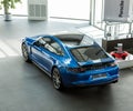 Blue Porsche Panamera 4S at the store