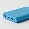 Blue portable power bank with a sleek, rectangular design and rounded edges. The Royalty Free Stock Photo