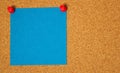 Blue post-it on a coarkboard background