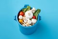 A blue pot with mushrooms and other vegetables on it. AI generation Royalty Free Stock Photo