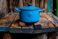 A blue pot sitting on top of a wooden table Royalty Free Stock Photo